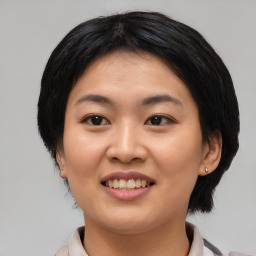 Joyful asian young-adult female with medium  black hair and brown eyes