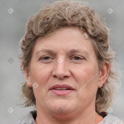 Joyful white adult female with medium  brown hair and blue eyes