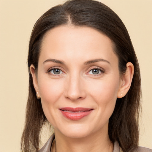 Joyful white young-adult female with long  brown hair and brown eyes