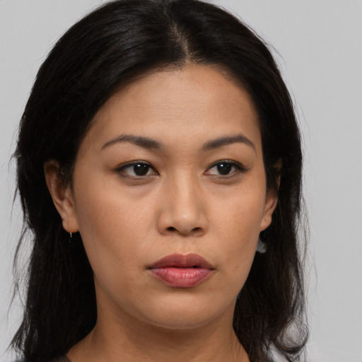 Joyful asian young-adult female with long  brown hair and brown eyes