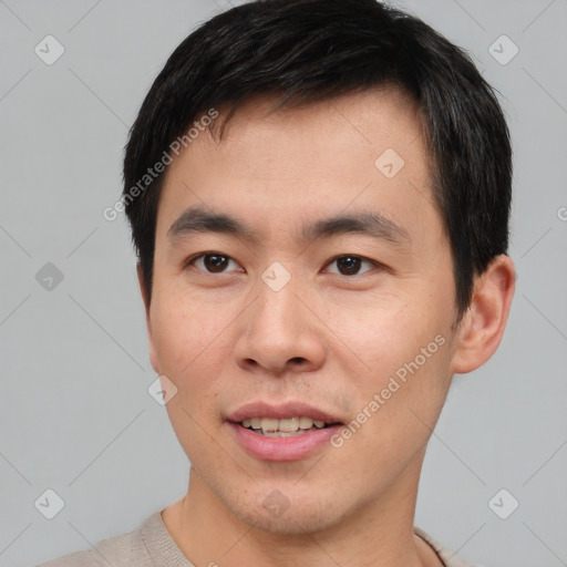 Joyful asian young-adult male with short  brown hair and brown eyes