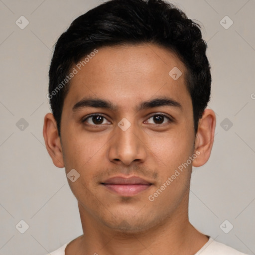 Joyful latino young-adult male with short  black hair and brown eyes