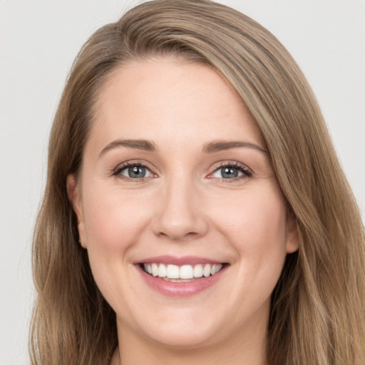 Joyful white young-adult female with long  brown hair and green eyes