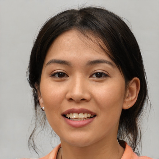 Joyful asian young-adult female with medium  brown hair and brown eyes