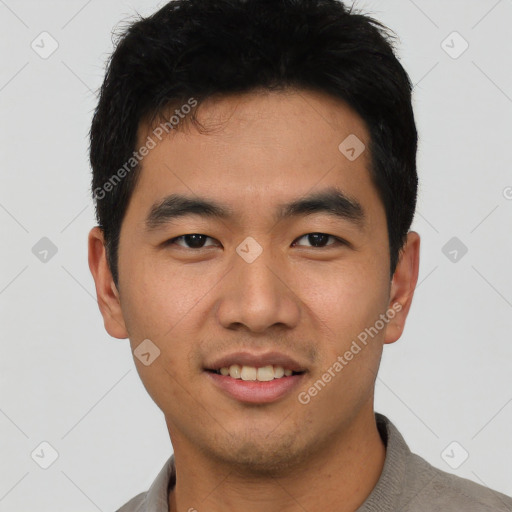 Joyful asian young-adult male with short  black hair and brown eyes