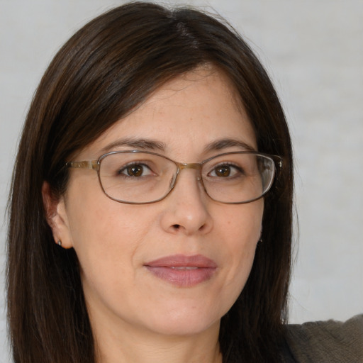 Joyful white adult female with medium  brown hair and brown eyes