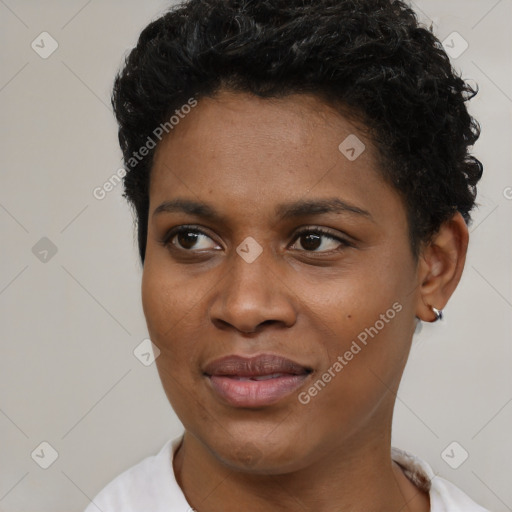 Joyful black young-adult female with short  black hair and brown eyes