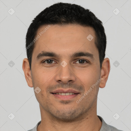 Joyful latino young-adult male with short  black hair and brown eyes