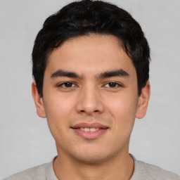 Joyful asian young-adult male with short  black hair and brown eyes