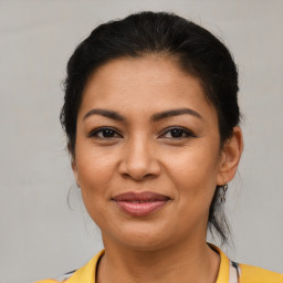 Joyful latino young-adult female with medium  brown hair and brown eyes