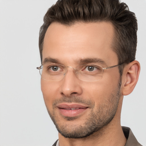 Joyful white adult male with short  brown hair and brown eyes