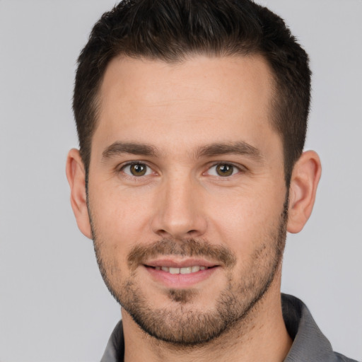 Joyful white young-adult male with short  brown hair and brown eyes