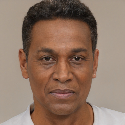 Joyful latino adult male with short  brown hair and brown eyes