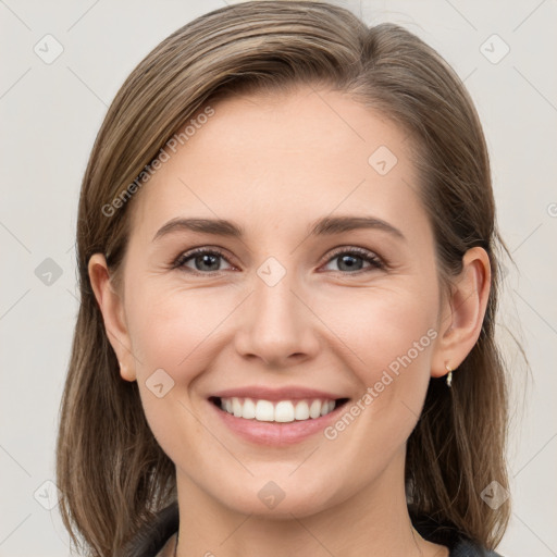 Joyful white young-adult female with long  brown hair and grey eyes