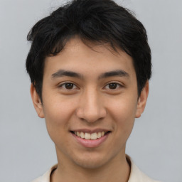 Joyful latino young-adult male with short  brown hair and brown eyes