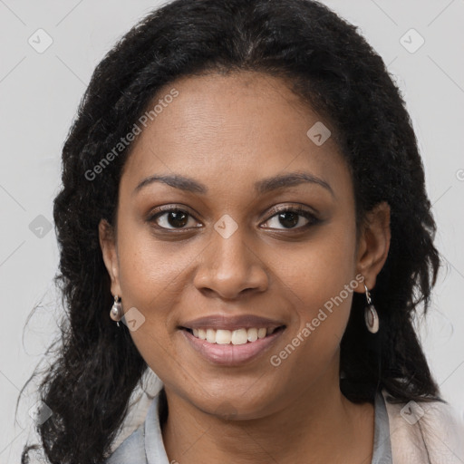 Joyful black young-adult female with long  black hair and brown eyes