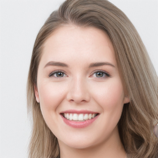 Joyful white young-adult female with long  brown hair and blue eyes