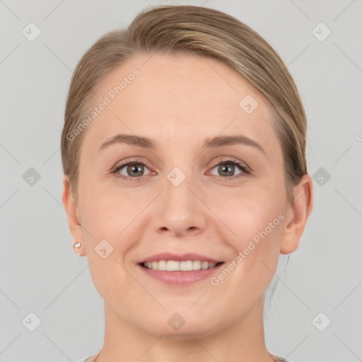 Joyful white young-adult female with short  brown hair and grey eyes