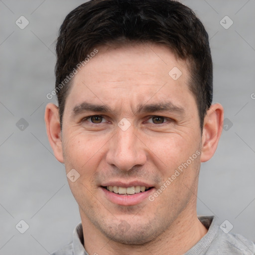 Joyful white adult male with short  brown hair and grey eyes