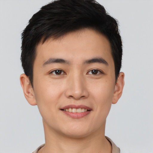 Joyful white young-adult male with short  black hair and brown eyes
