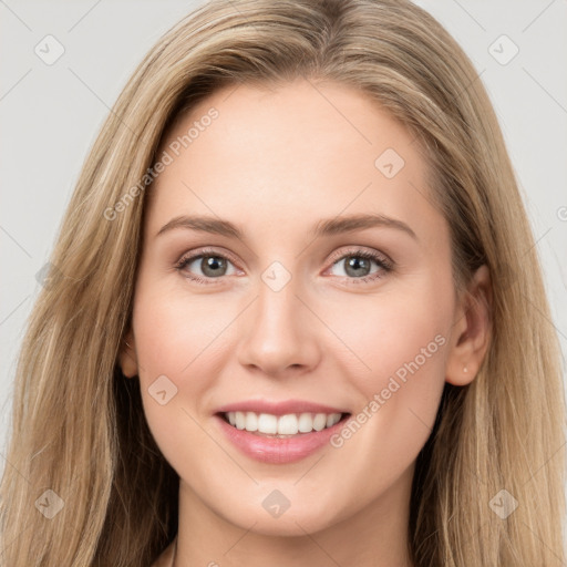 Joyful white young-adult female with long  brown hair and grey eyes