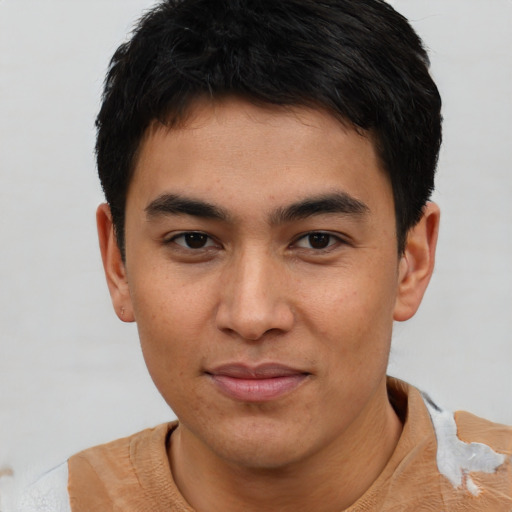 Joyful asian young-adult male with short  brown hair and brown eyes