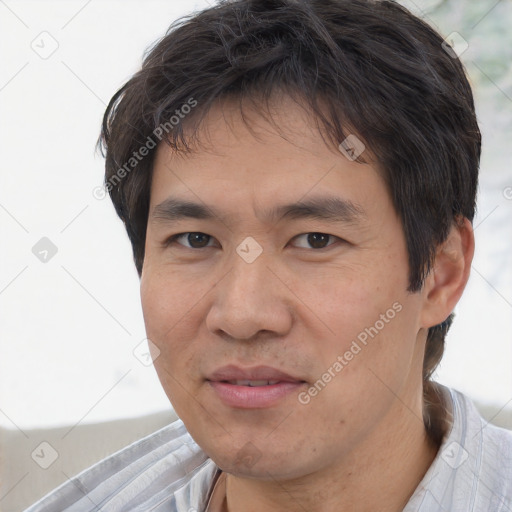 Joyful asian adult male with short  brown hair and brown eyes