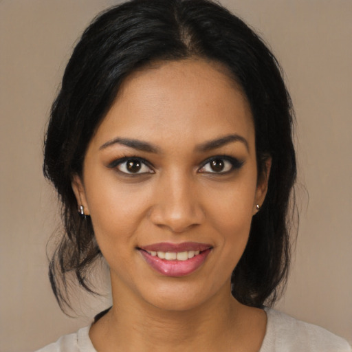 Joyful black young-adult female with medium  brown hair and brown eyes