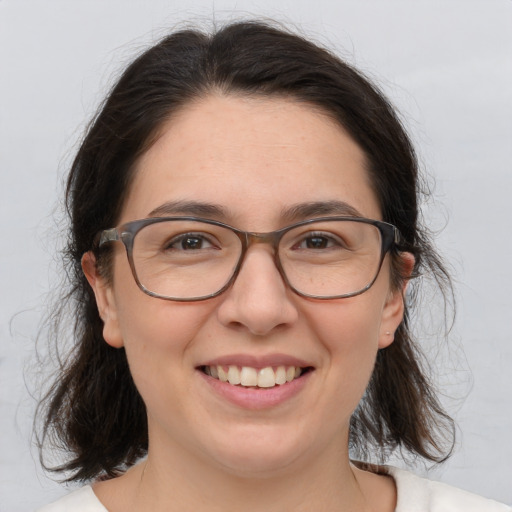 Joyful white adult female with medium  brown hair and brown eyes