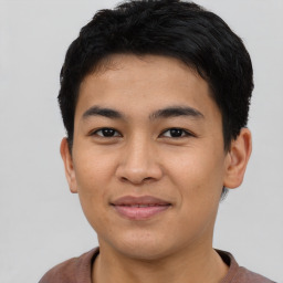 Joyful asian young-adult male with short  brown hair and brown eyes