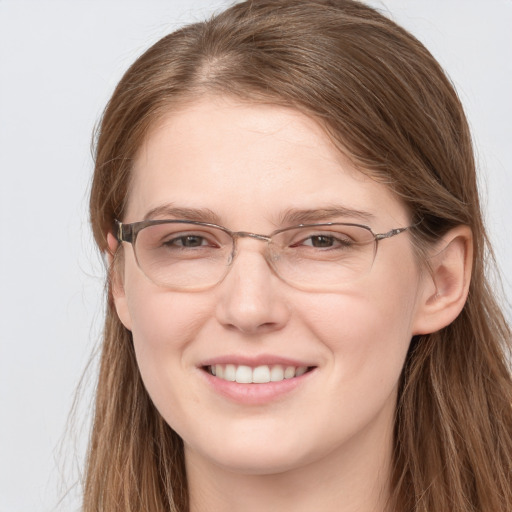 Joyful white young-adult female with long  brown hair and grey eyes