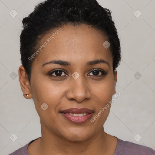 Joyful black young-adult female with short  black hair and brown eyes