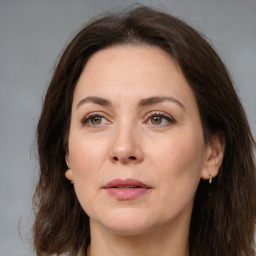 Joyful white adult female with medium  brown hair and brown eyes