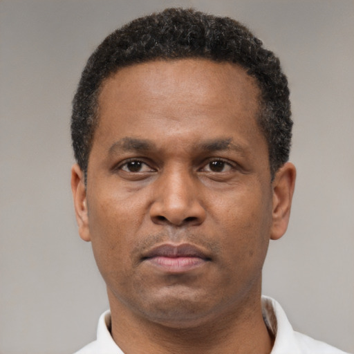 Neutral latino adult male with short  black hair and brown eyes