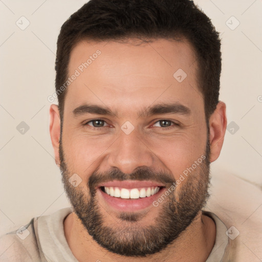 Joyful white young-adult male with short  brown hair and brown eyes