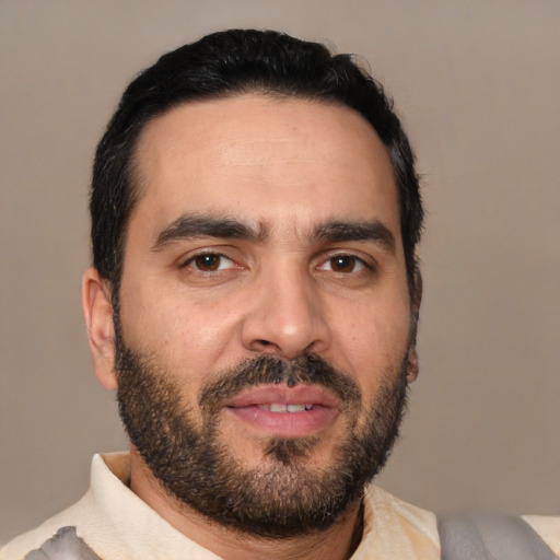 Joyful white young-adult male with short  black hair and brown eyes