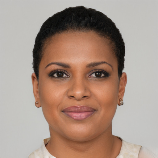 Joyful black young-adult female with short  brown hair and brown eyes
