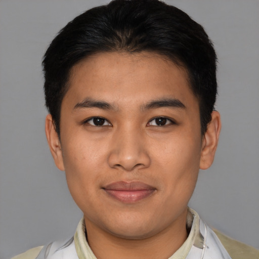 Joyful asian young-adult male with short  brown hair and brown eyes