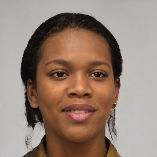 Joyful black young-adult female with long  black hair and brown eyes