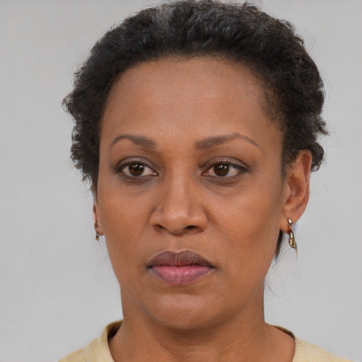 Joyful black adult female with short  brown hair and brown eyes
