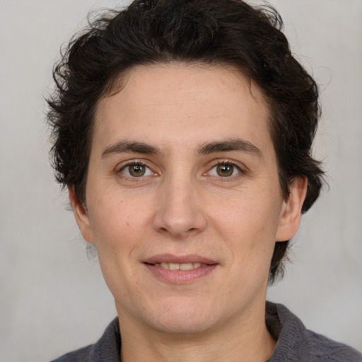 Joyful white adult male with medium  brown hair and brown eyes