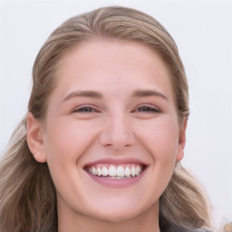 Joyful white young-adult female with long  brown hair and blue eyes