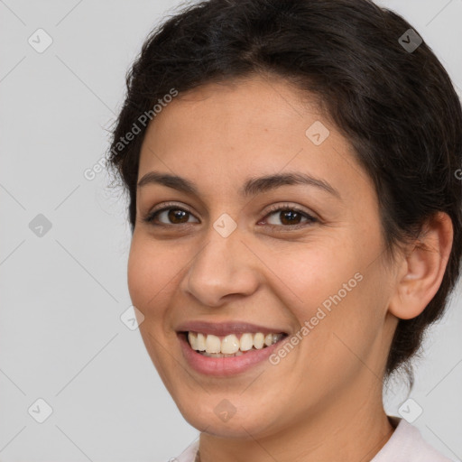 Joyful white young-adult female with short  brown hair and brown eyes