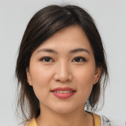 Joyful asian young-adult female with medium  brown hair and brown eyes