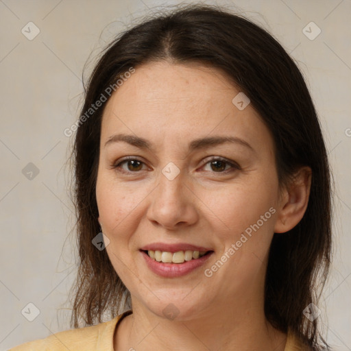 Joyful white adult female with medium  brown hair and brown eyes