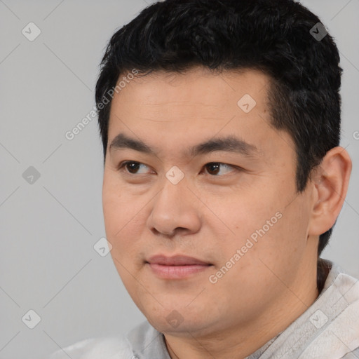 Joyful asian young-adult male with short  black hair and brown eyes