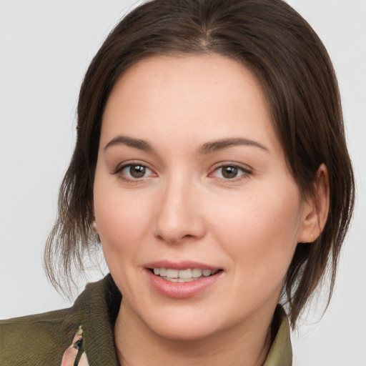 Joyful white young-adult female with medium  brown hair and brown eyes