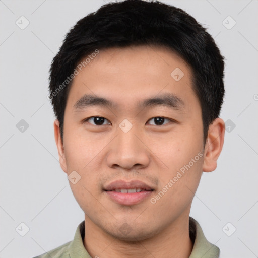 Joyful asian young-adult male with short  black hair and brown eyes