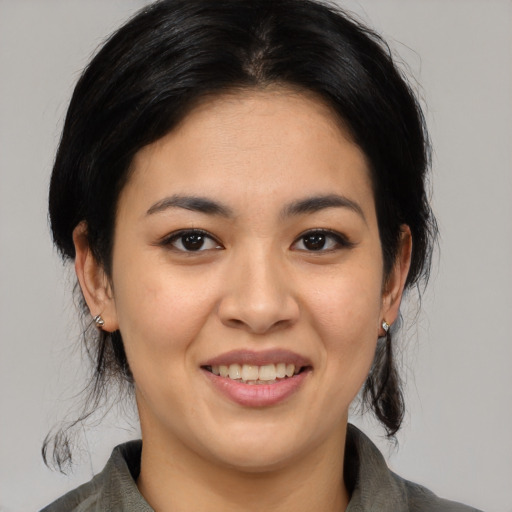 Joyful asian young-adult female with medium  black hair and brown eyes