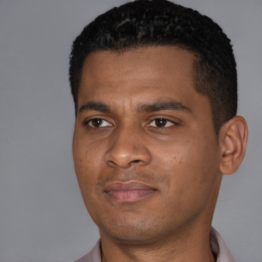 Joyful black young-adult male with short  black hair and brown eyes